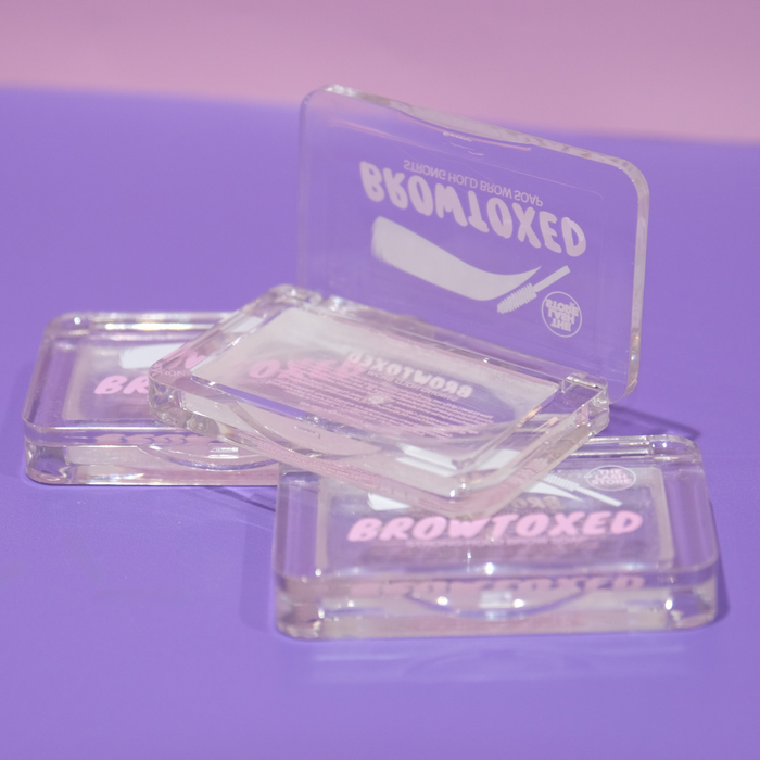 Clear BrowToxed product packaging on a purple background