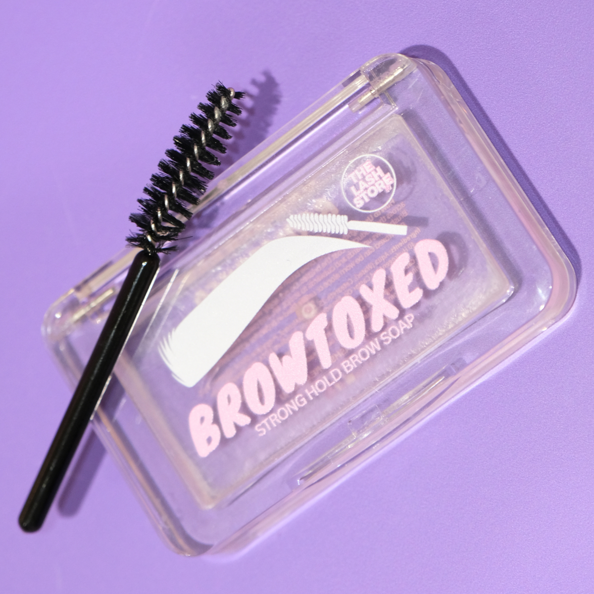 Browtoxed strong hold brow soap with brush on a purple background