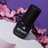 Black lash extension adhesive bottle with pink floral background