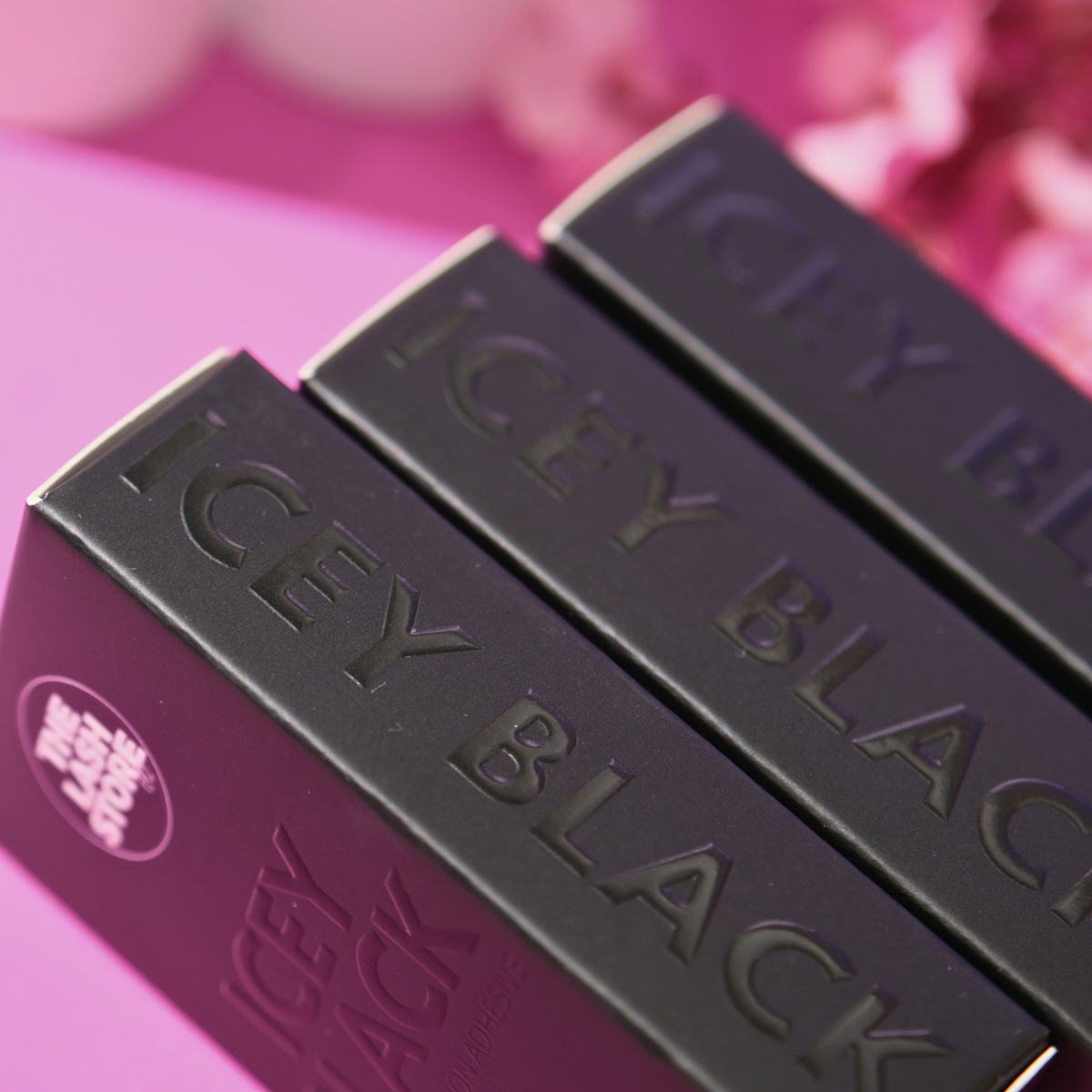 Three lipsticks with 'ICY BLACK' text on a pink background